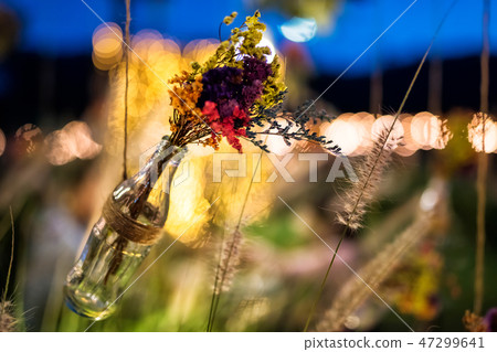 fake flowers in bottle with bokeh in garden fake flowers in bottle with bokeh in garden 47299641
