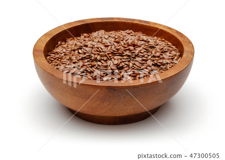 Flax seeds in wooden bowl Flax seeds in wooden bowl 47300505