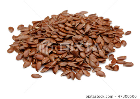 Heap of flax seeds on white background Heap of flax seeds on white background 47300506