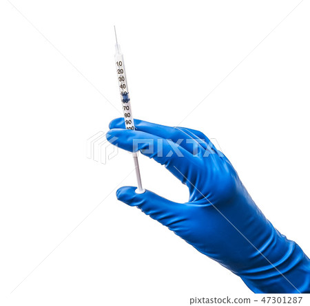 Doctor's hand in blue medical glove holding open syringe with medical solution isolated white 47301287