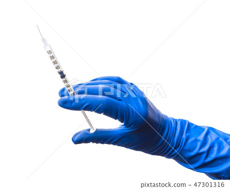 Doctor's hand in blue medical glove holding open syringe with medical solution isolated white 47301316