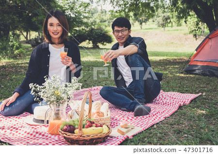 Couple in love drink a orange juice on summer picnic, leisure, h 47301716