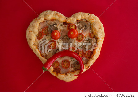 Pizza heart shaped on red Pizza heart shaped on red 47302182
