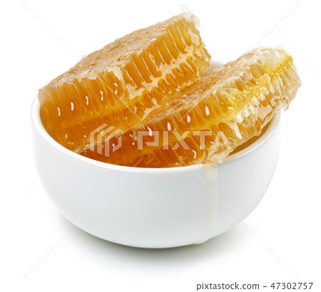 Honeycomb in white bowl on white background Honeycomb in white bowl on white background 47302757