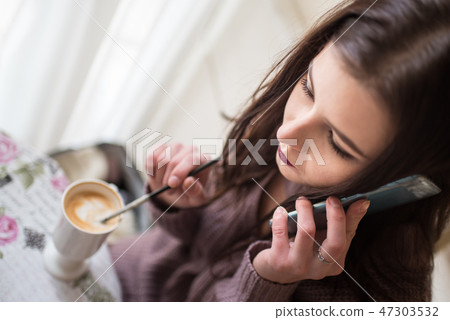 Beautiful Caucasian young women speaks by phone 47303532