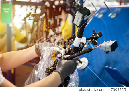 Worker is packing a wiring harnesses Worker is packing a wiring harnesses 47303535