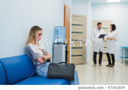 A doctor and a nurse discussing the Diagnosis with the patient or relative in the Hospital floor 47303834