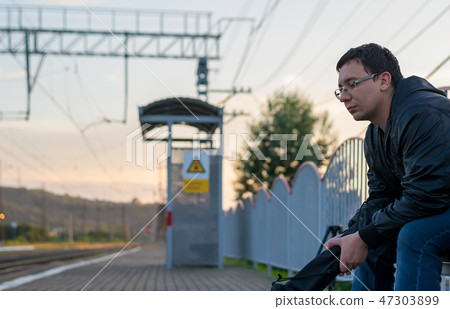 Man sitting on the street on the platform 47303899