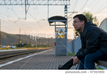 Man sitting on the street on the platform 47303900