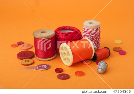 closeup of sewing set on orange background closeup of sewing set on orange background 47304566
