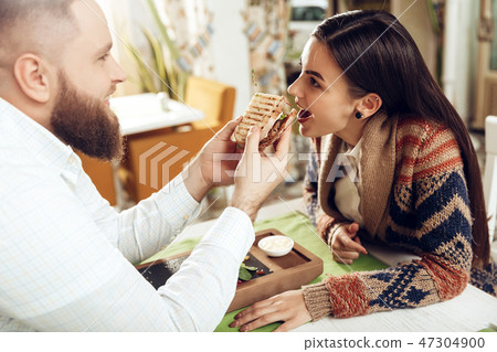 Happy man and woman having lunch in a restaurant Happy man and woman having lunch in a restaurant 47304900