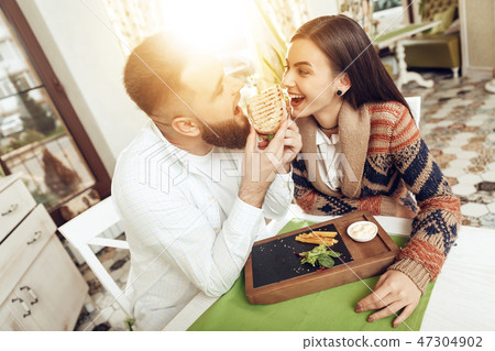 Happy man and woman having lunch in a restaurant Happy man and woman having lunch in a restaurant 47304902