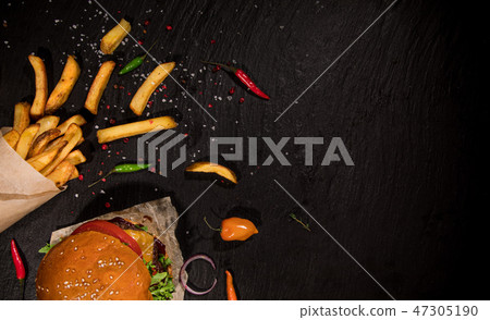 Top view of tasty burgers on wooden table. 47305190