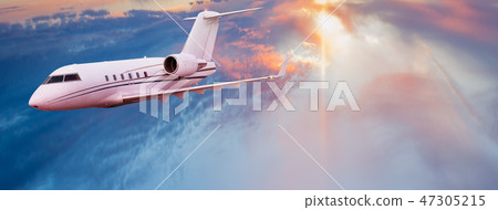 Small private jetplane flying above beautiful clouds. 47305215