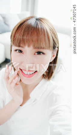 woman selfie with teeth retainer 47307145