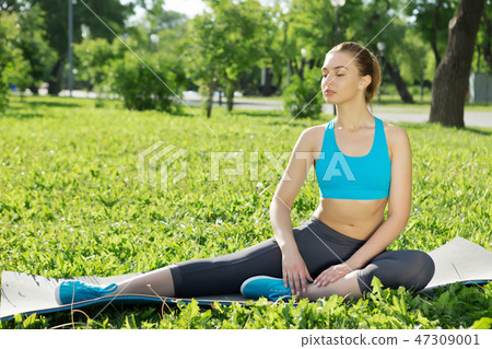 Girl practicing stretching exercises Girl practicing stretching exercises 47309001