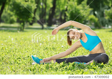 Girl practicing stretching exercises Girl practicing stretching exercises 47309002