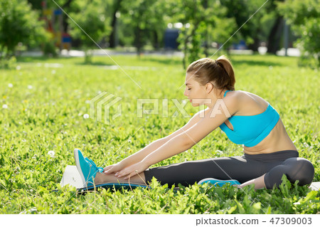 Girl practicing stretching exercises 47309003