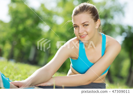 Girl practicing stretching exercises Girl practicing stretching exercises 47309011