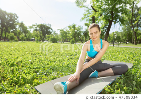 Girl practicing stretching exercises Girl practicing stretching exercises 47309034