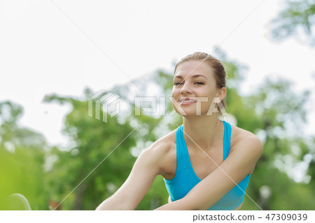 Girl practicing stretching exercises Girl practicing stretching exercises 47309039