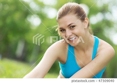 Girl practicing stretching exercises Girl practicing stretching exercises 47309040