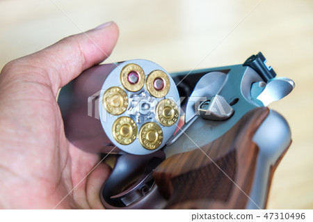 .44 magnum revolver gun with bullet on wood 47310496