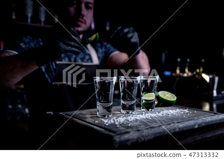 aperitif with friends in the bar, three glasses of alcohol with lime and salt for decoration aperitif with friends in the bar, three glasses of alcohol with lime and salt for decoration 47313332