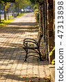 park bench in a city in autumnal sun 47313898