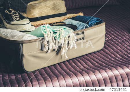Open suitcase with female clothes for travel.  47315461