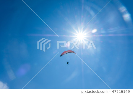 Paraglider flying against the blue sky 47316149