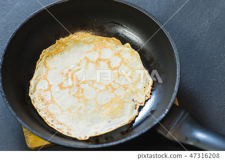 Stack of pancakes on frying pan. 47316208