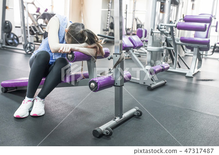 Portrait of tired woman having rest after workout Portrait of tired woman having rest after workout 47317487