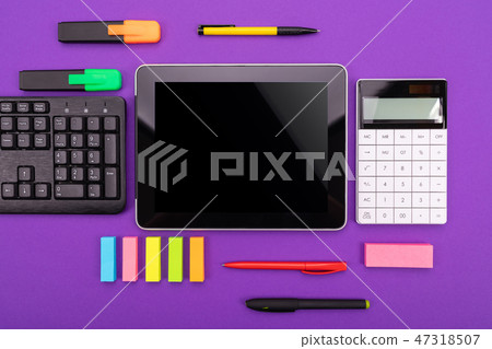 Modern workspace with tablet, keyboard and calculator on purple background. Flat lay concept Modern workspace with tablet, keyboard and calculator on purple background. Flat lay concept 47318507