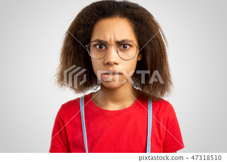 nervous young African American female bites lips nervous young African American female bites lips 47318510
