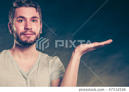 Man with open empty hand palm for copy space. 47318586