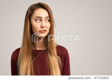 Dissatisfied female frowns face 47318603
