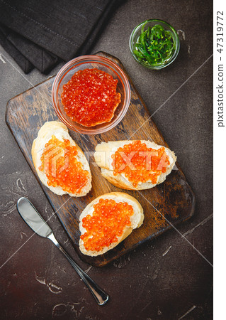 Delicious appetizer with red caviar. 47319772
