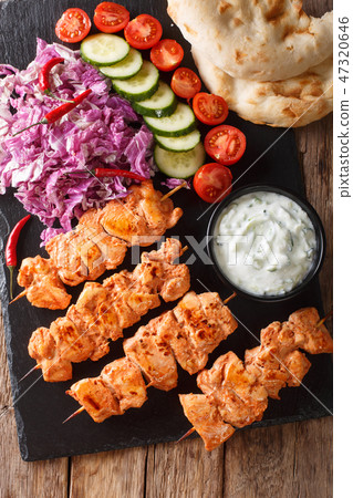 Traditional Taouk chicken kebab with fresh salad Traditional Taouk chicken kebab with fresh salad 47320646