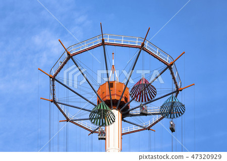 A sky flower of an umbrella shaped vehicle at Tokyo Dome City Amusement Park in Korakuen, Tokyo. A sky flower of an umbrella shaped vehicle at Tokyo Dome City Amusement Park in Korakuen, Tokyo. 47320929