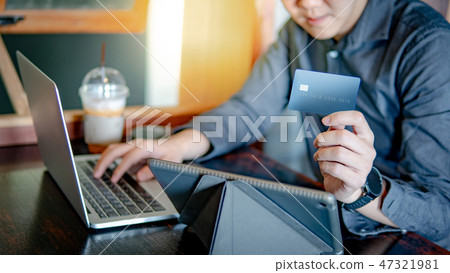 Asian man using credit card for online shopping 47321981