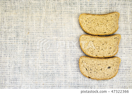 Slice whole wheat bread on natural fabric Slice whole wheat bread on natural fabric 47322366
