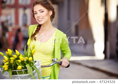 Woman wearing a spring skirt like vintage pin-up holding bicycle Woman wearing a spring skirt like vintage pin-up holding bicycle 47324328