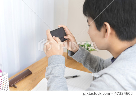 Boys playing games on smartphones 47324603