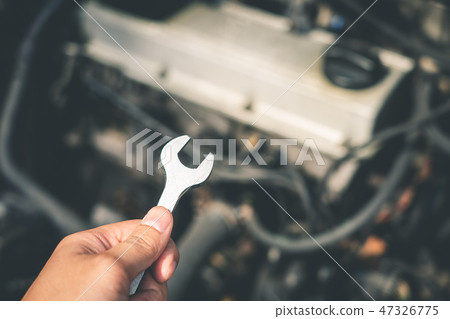 mechanical engineer hands open the car skirt to  47326775