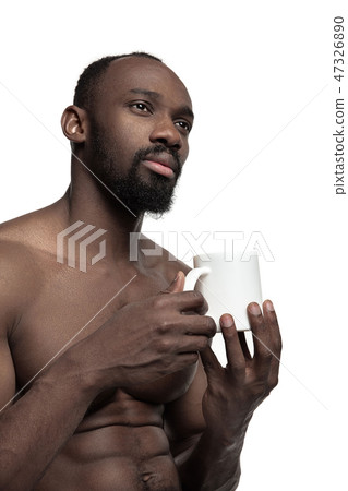 African man with cup of tea, isolated on white background African man with cup of tea, isolated on white background 47326890