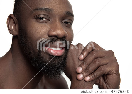 Close up portrait of a young naked african man indoors Close up portrait of a young naked african man indoors 47326898