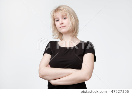 Lovely confused blonde woman in black t-shirt Lovely confused blonde woman in black t-shirt 47327306