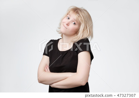 Lovely confused blonde woman in black t-shirt Lovely confused blonde woman in black t-shirt 47327307