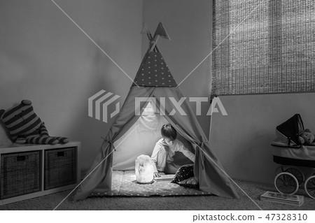 Boy playing in the teepee Boy playing in the teepee 47328310
